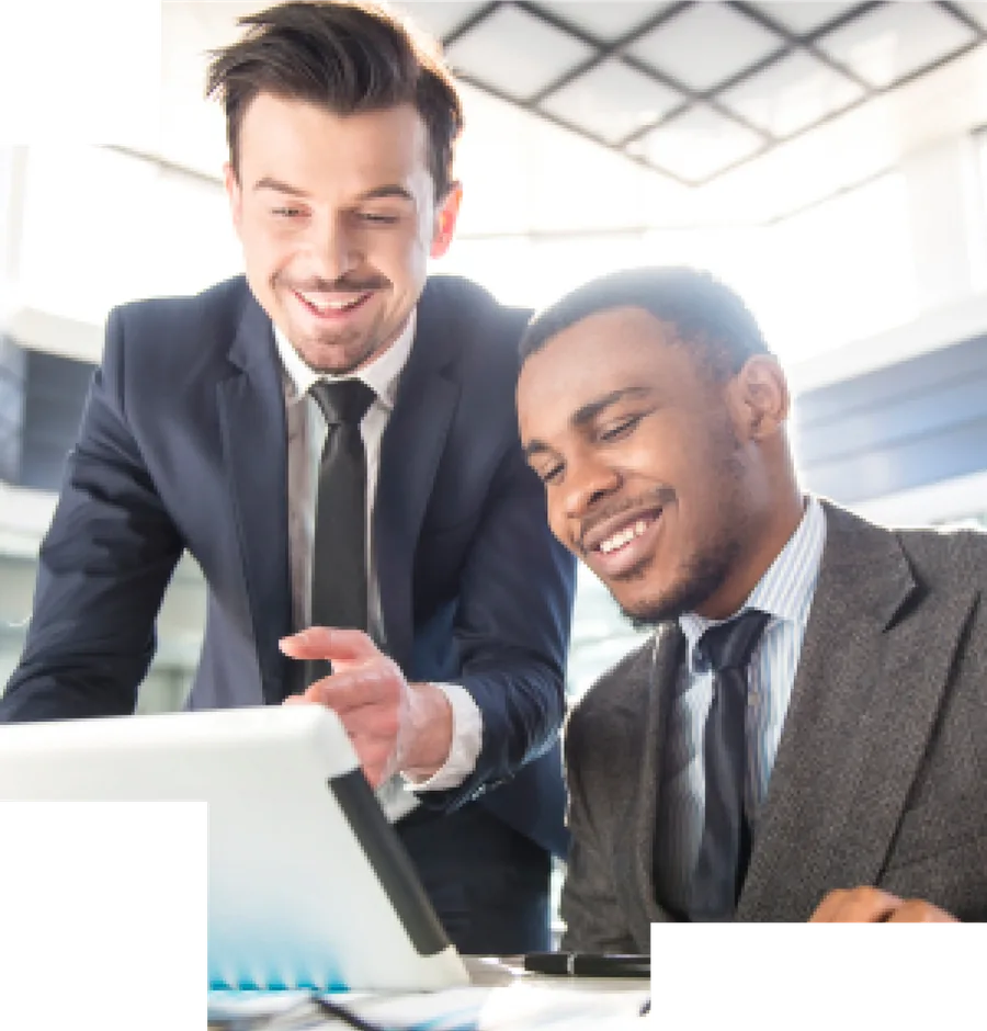 Two advisors smiling at a laptop