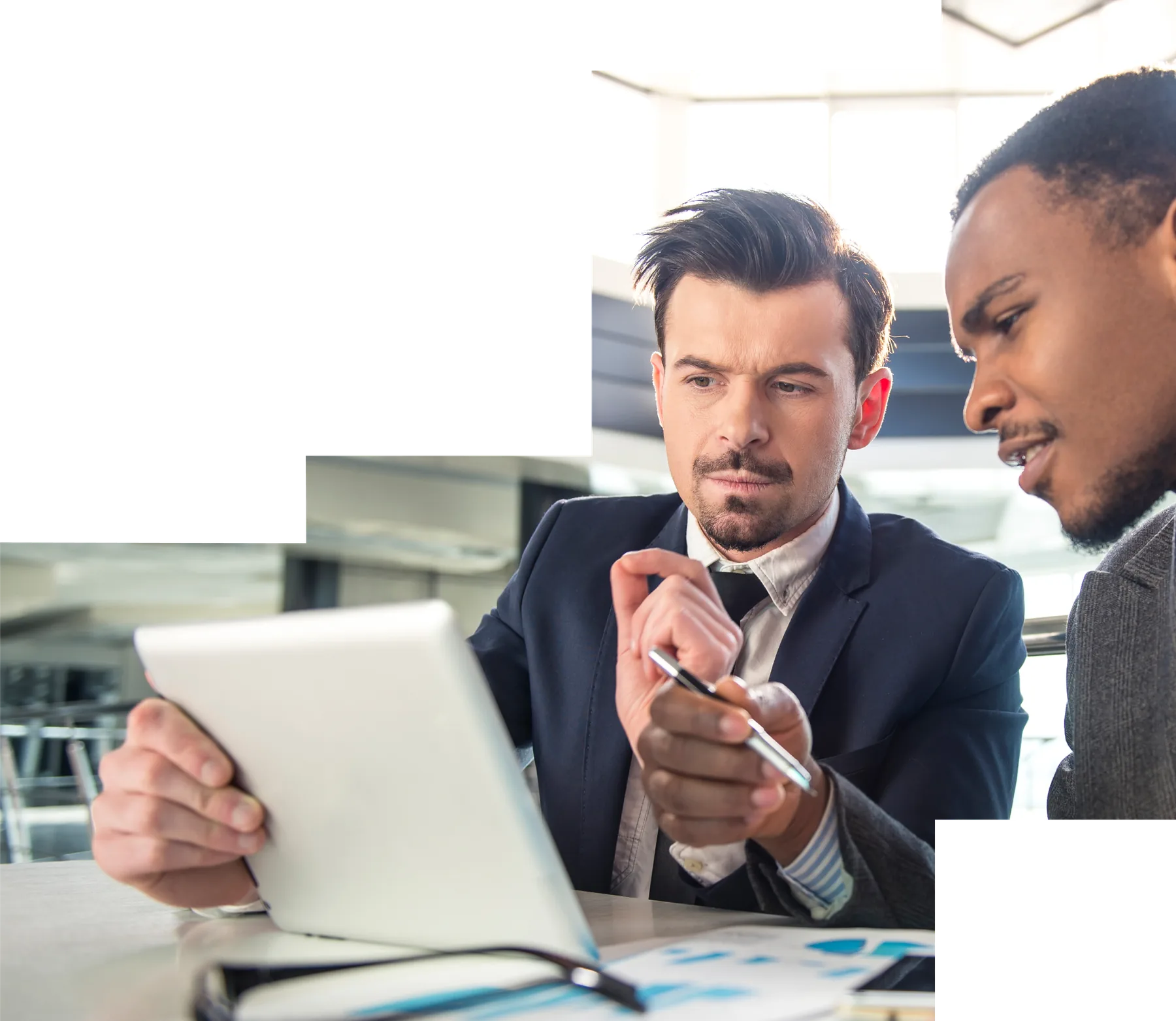 Two advisors reviewing a portfolio on a tablet