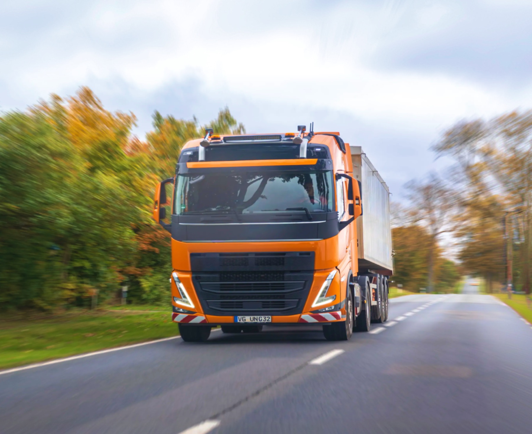 Orange truck on a country road
